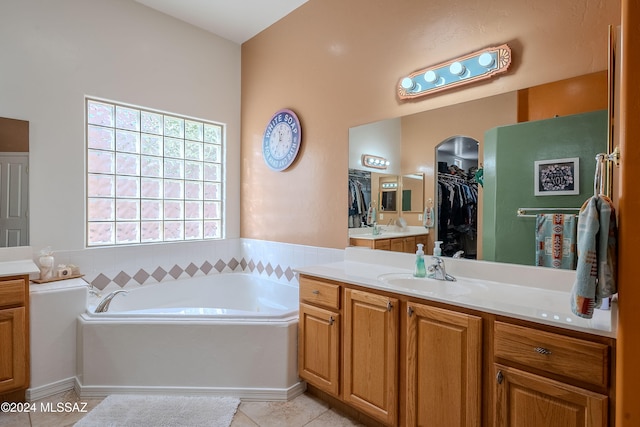 bathroom with vanity, a tub, and tile patterned flooring