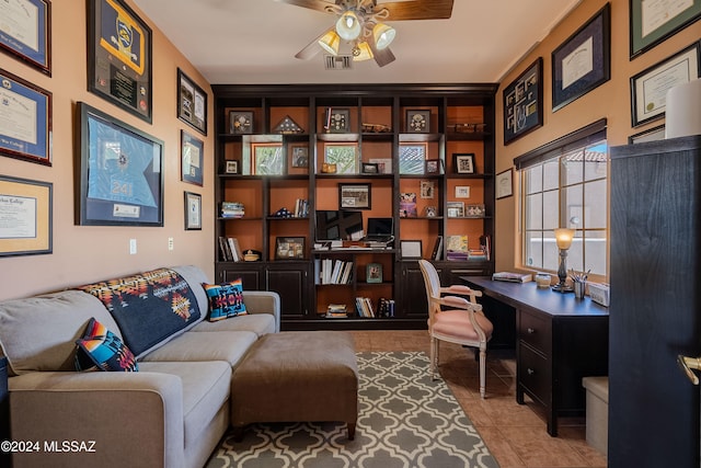 tiled office space featuring ceiling fan