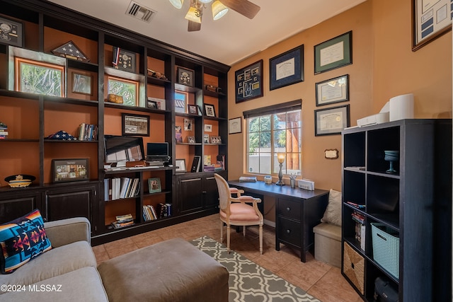 office area with built in desk, light tile patterned floors, and ceiling fan