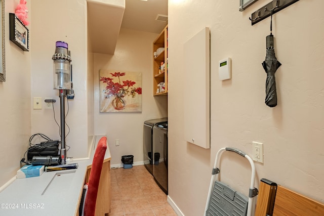 laundry room featuring washer and dryer and light tile patterned floors