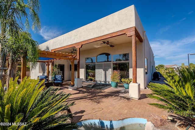 rear view of house featuring a pergola, a patio, and ceiling fan