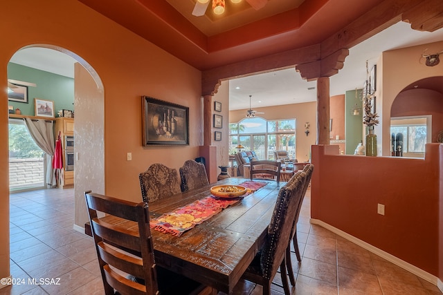 tiled dining room featuring a healthy amount of sunlight and ceiling fan