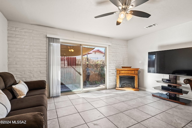 tiled living room with ceiling fan