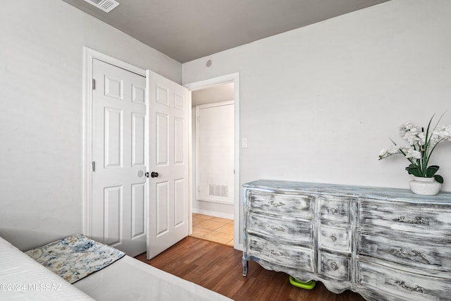 bedroom featuring dark hardwood / wood-style floors and a closet