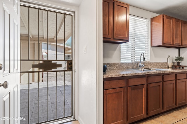 kitchen featuring light tile patterned flooring and sink