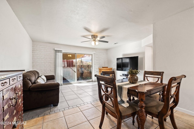 tiled dining room with ceiling fan and a textured ceiling