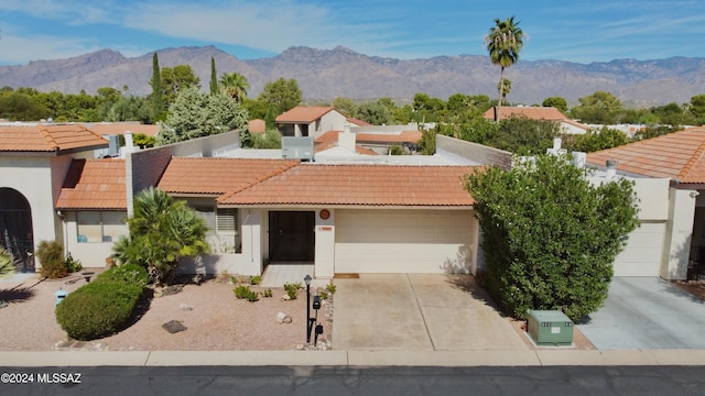 view of front of house featuring a garage and a mountain view