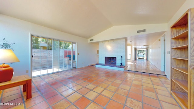 unfurnished living room featuring lofted ceiling, tile patterned flooring, and a fireplace