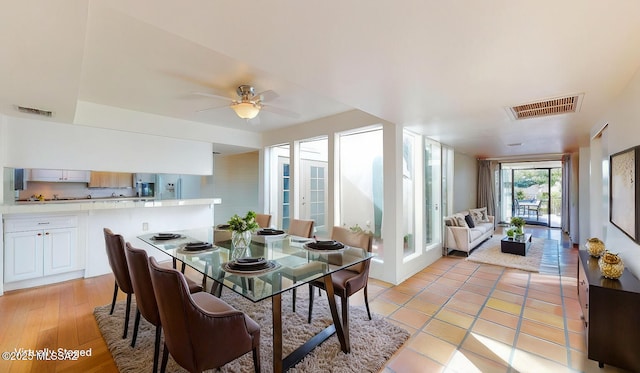 dining area featuring french doors, visible vents, and a ceiling fan