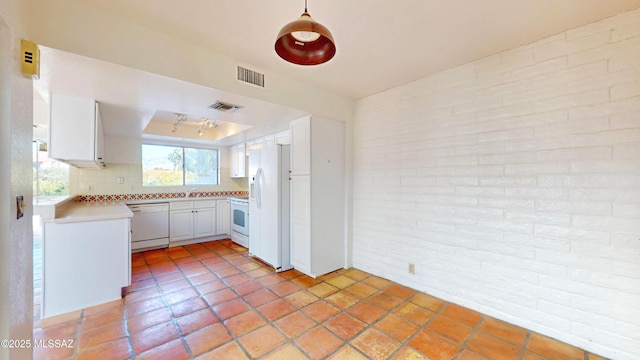 kitchen featuring brick wall, white appliances, visible vents, white cabinets, and light countertops