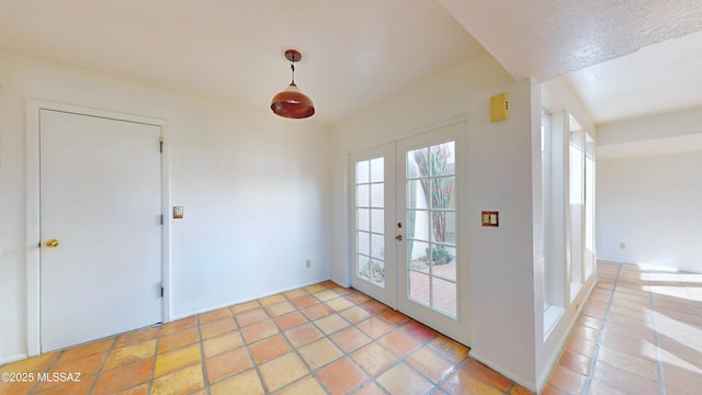 doorway with light tile patterned floors and french doors