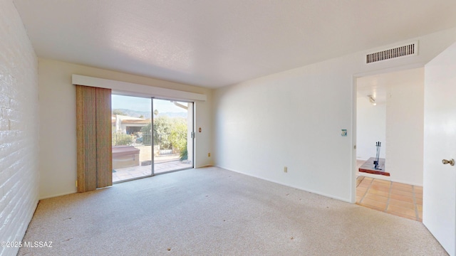 unfurnished room featuring light carpet and visible vents