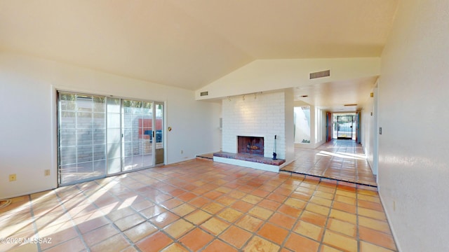 living area with visible vents, light carpet, and brick wall