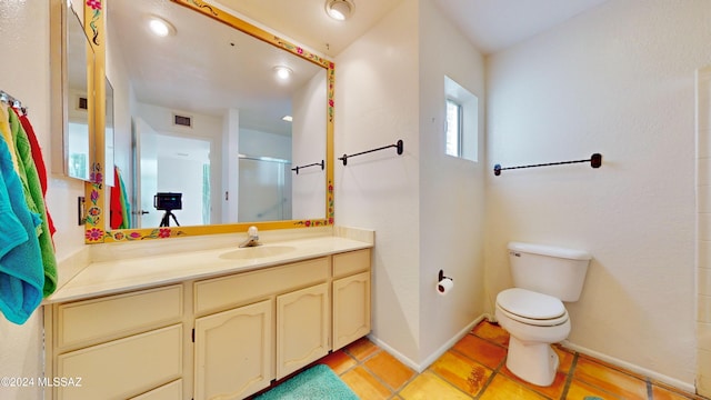 bathroom with vanity, toilet, and an enclosed shower