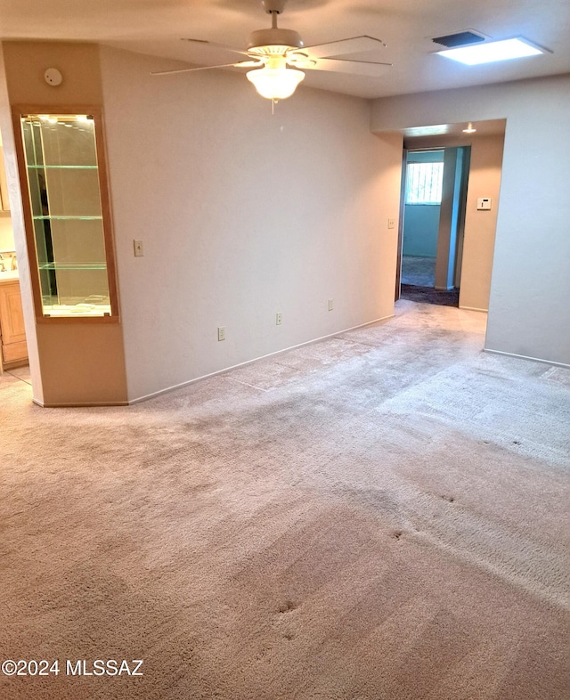 empty room featuring light carpet and ceiling fan