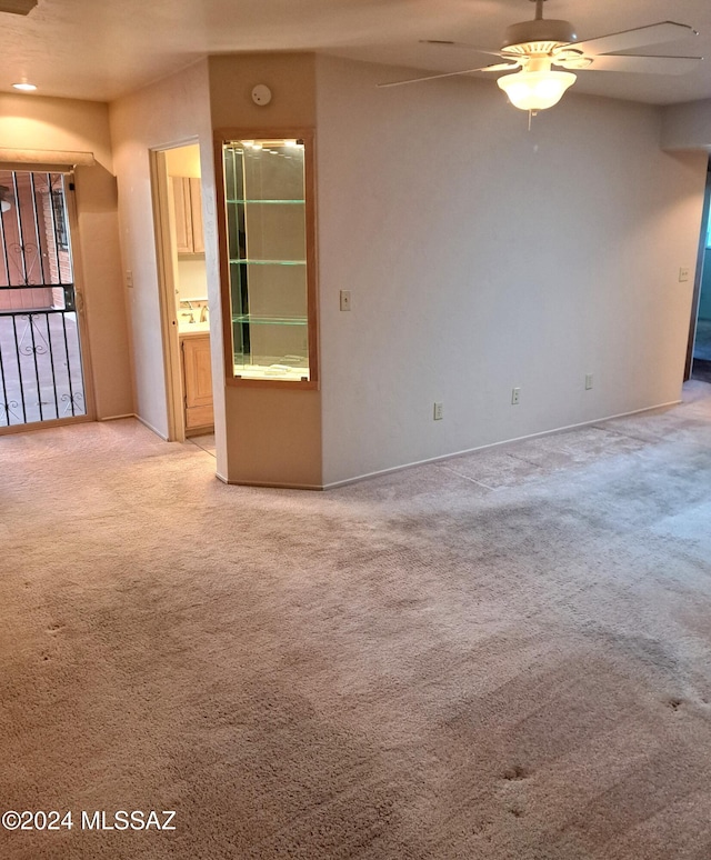 empty room with light carpet and ceiling fan