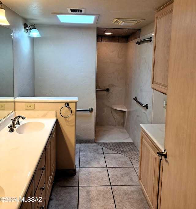 bathroom with vanity, tile patterned floors, and walk in shower