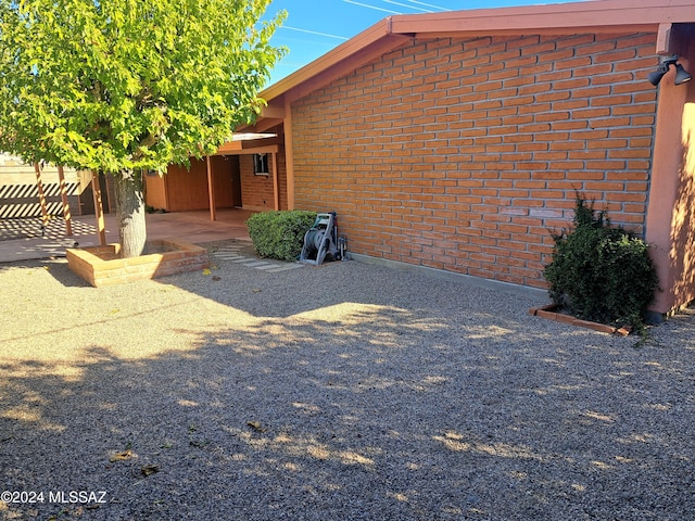 view of property exterior with a patio