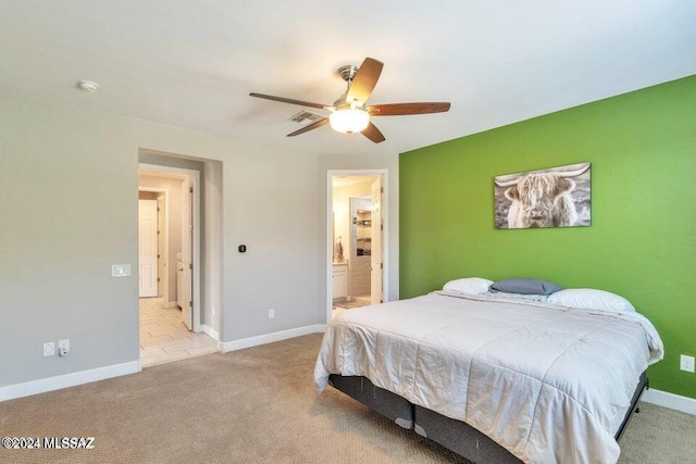 carpeted bedroom featuring ensuite bathroom and ceiling fan