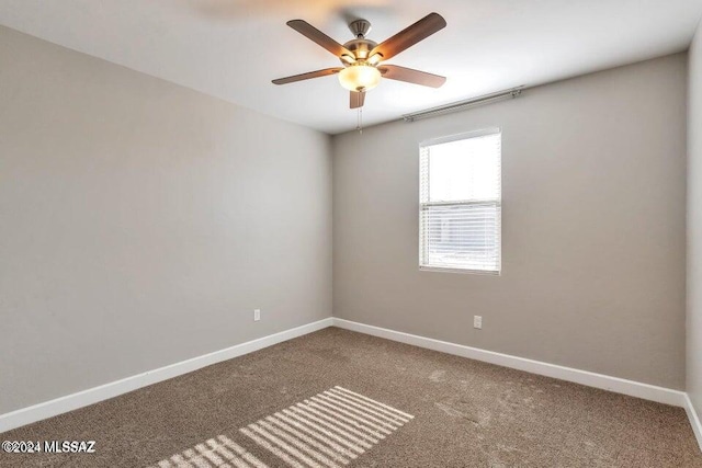 empty room featuring carpet floors and ceiling fan