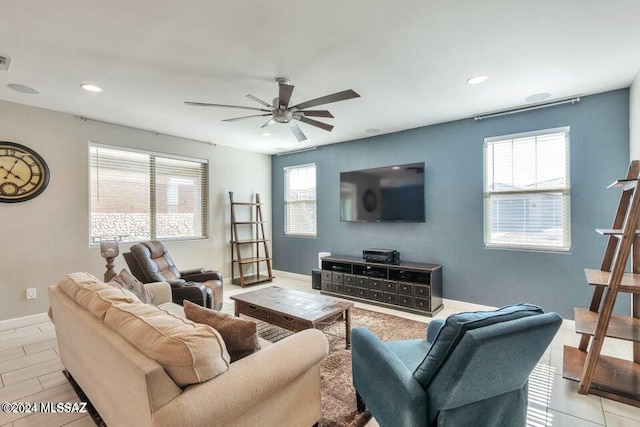 living room featuring a wealth of natural light and ceiling fan