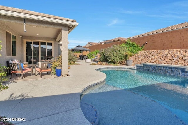 view of swimming pool with a patio area