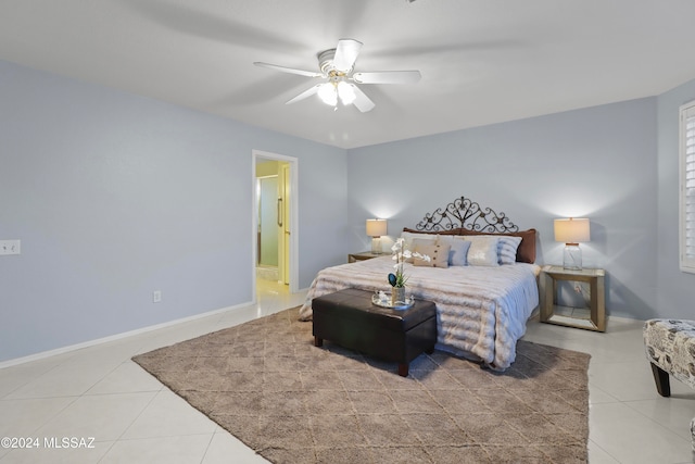 tiled bedroom featuring ceiling fan and ensuite bathroom