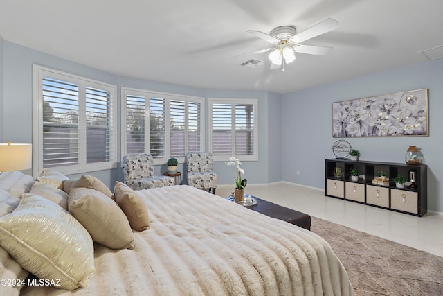 tiled bedroom featuring ceiling fan