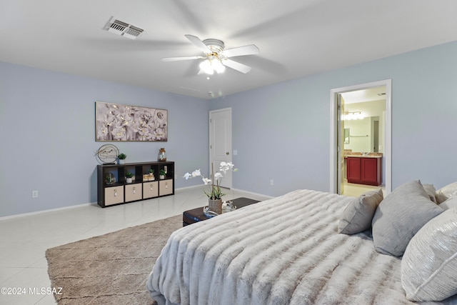 bedroom with ceiling fan, light tile patterned floors, and ensuite bath