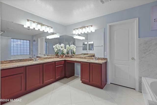 bathroom featuring vanity, a textured ceiling, tile patterned floors, and a bathtub