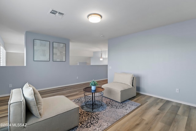 sitting room with wood-type flooring