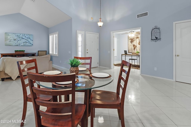 tiled dining room featuring lofted ceiling and ceiling fan