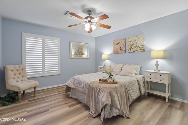 bedroom with light hardwood / wood-style floors and ceiling fan