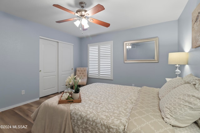 bedroom with a closet, wood-type flooring, and ceiling fan