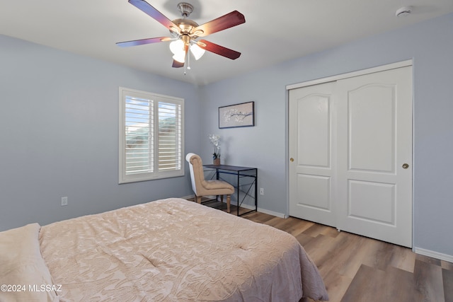 bedroom with a closet, ceiling fan, and light hardwood / wood-style floors