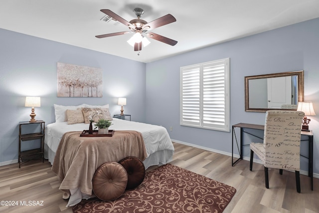 bedroom with light wood-type flooring and ceiling fan