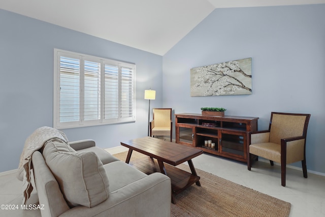 living room featuring vaulted ceiling and light tile patterned floors