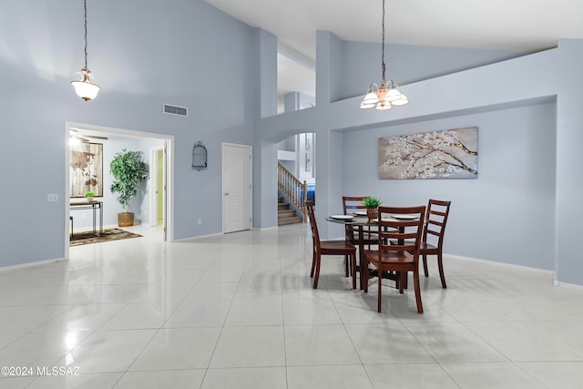 dining space with a notable chandelier, high vaulted ceiling, and light tile patterned floors