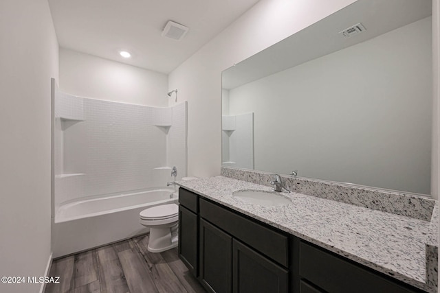 full bathroom with toilet, bathtub / shower combination, vanity, and hardwood / wood-style flooring