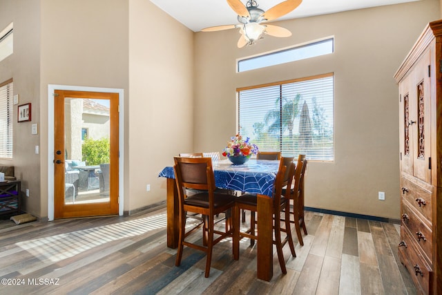 dining room featuring dark hardwood / wood-style floors, ceiling fan, and lofted ceiling