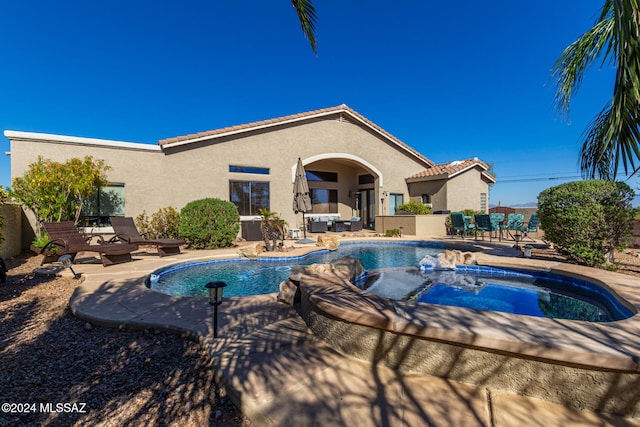 view of pool with a patio area and an in ground hot tub