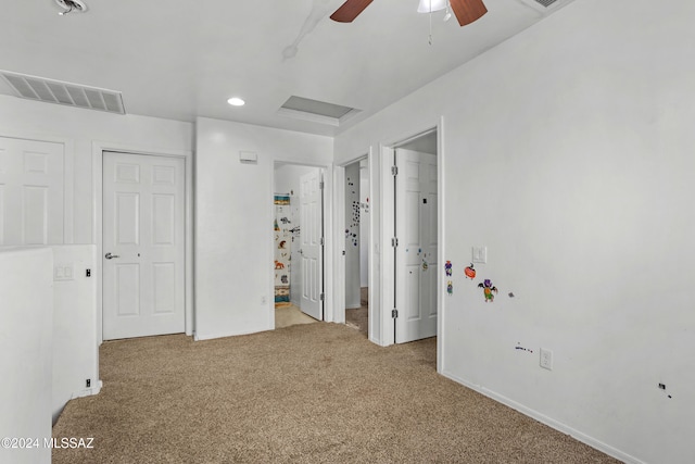 unfurnished bedroom with carpet, ceiling fan, and a closet