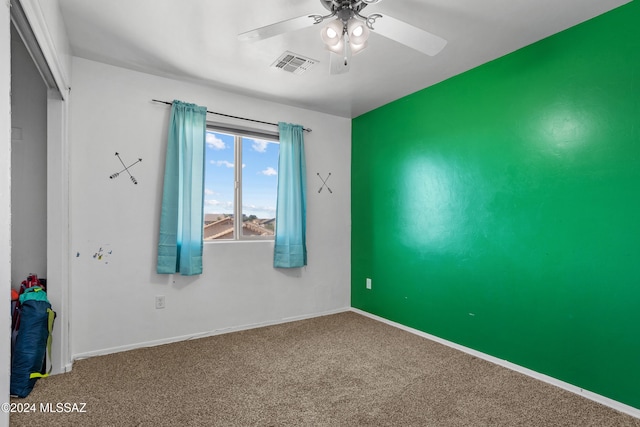 carpeted empty room with ceiling fan