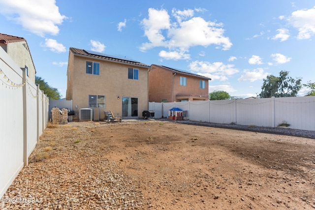 back of property featuring central AC