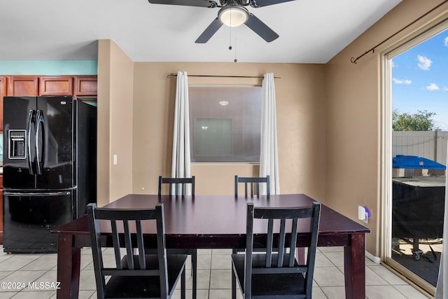 tiled dining space featuring ceiling fan