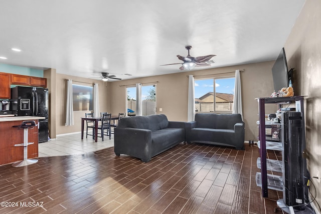 living room featuring dark hardwood / wood-style flooring and ceiling fan