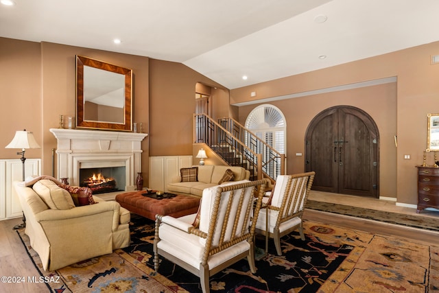 living room with light hardwood / wood-style floors and lofted ceiling