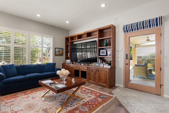 living room featuring light hardwood / wood-style floors and ceiling fan