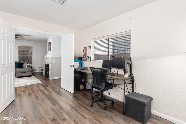 office with dark hardwood / wood-style flooring and ceiling fan