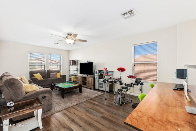 living room with ceiling fan and dark wood-type flooring